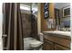 Bathroom with shower-tub combo, wood vanity, framed mirror, and tile accents at 5450 N Globe Dr, Eloy, AZ 85131