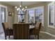 Dining room featuring large windows and a decorative chandelier, offering abundant natural light and space at 5450 N Globe Dr, Eloy, AZ 85131