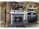 A stone fireplace with wood mantle and mounted TV, along with a built-in wet bar and decorative accents at 5450 N Globe Dr, Eloy, AZ 85131