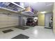 Spacious garage featuring storage racks, epoxy floors, ample lighting, and a golf cart at 5450 N Globe Dr, Eloy, AZ 85131