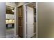 Hallway view featuring a storage cabinet and office with built-in desk and cabinets at 5450 N Globe Dr, Eloy, AZ 85131