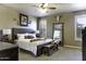 Main bedroom featuring neutral decor, a king-size bed, decorative accents, and ample natural light at 5450 N Globe Dr, Eloy, AZ 85131