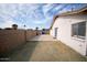 Backyard with a block fence, window, and a door leading to the house at 5608 W Greenbriar Dr, Glendale, AZ 85308