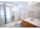 Bathroom featuring a shower with glass doors, tiled floor, and a sink with wood vanity at 5608 W Greenbriar Dr, Glendale, AZ 85308