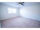 Carpeted bedroom featuring a ceiling fan, window with blinds, and neutral color palette at 5608 W Greenbriar Dr, Glendale, AZ 85308