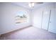 Bedroom showcasing a charming arched window with an outside view and closet at 5608 W Greenbriar Dr, Glendale, AZ 85308