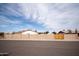 Street view of a block wall fenced-in single-story home under a partly cloudy blue sky at 5608 W Greenbriar Dr, Glendale, AZ 85308