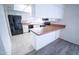 Bright kitchen features black appliances and a breakfast bar with tiled countertops at 5608 W Greenbriar Dr, Glendale, AZ 85308