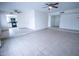 Living room featuring tiled floor, multiple ceiling fans, access to kitchen and bonus room at 5608 W Greenbriar Dr, Glendale, AZ 85308