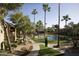 Inviting pool area surrounded by lush landscaping and walkways, offering a serene outdoor space at 5877 N Granite Reef Rd # 2243, Scottsdale, AZ 85250