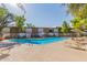 Community swimming pool with plenty of lounge chairs and umbrellas for tenants at 6125 E Indian School Rd # 228, Scottsdale, AZ 85251