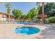 Inviting community pool and spa surrounded by umbrellas and lounge chairs at 6125 E Indian School Rd # 228, Scottsdale, AZ 85251