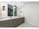 Sleek primary bathroom with dual vanities, modern lighting, and a minimalist design at 6338 N 10Th Dr, Phoenix, AZ 85013