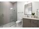 Modern bathroom with a glass-enclosed shower, sleek vanity, and contemporary fixtures at 6338 N 10Th Dr, Phoenix, AZ 85013