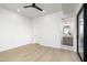 Minimalist bedroom with hardwood floors, a sliding glass door, and an ensuite bathroom at 6338 N 10Th Dr, Phoenix, AZ 85013