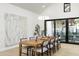 Dining area features a long wood table, seating for ten, and a modern light fixture at 6338 N 10Th Dr, Phoenix, AZ 85013