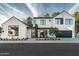 Contemporary two-story home boasts black trim windows, desert landscaping, and inviting outdoor seating area at 6338 N 10Th Dr, Phoenix, AZ 85013