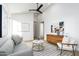 Comfortable living room featuring a gray sofa, bright white walls, and modern furnishings at 6338 N 10Th Dr, Phoenix, AZ 85013