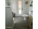 Bathroom featuring grey tile, toilet, wood vanity and a glass shower at 6458 W Adobe Dr, Glendale, AZ 85308