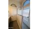 Bathroom featuring modern glass shower with window and tiled walls at 6458 W Adobe Dr, Glendale, AZ 85308