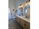 Bright bathroom with double sink vanity and modern lighting at 6458 W Adobe Dr, Glendale, AZ 85308