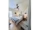 Bedroom featuring ceiling fan, light hardwood flooring, and neutral decor at 6458 W Adobe Dr, Glendale, AZ 85308