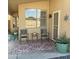 Cozy covered patio with tiled floor, seating, and a decorative southwestern-style rug at 6458 W Adobe Dr, Glendale, AZ 85308