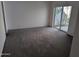 Carpeted bedroom featuring natural light and sliding glass door to outdoor area at 7161 E Mcdonald E Dr # 2, Paradise Valley, AZ 85253