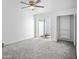 Bright bedroom featuring a ceiling fan, sliding glass door, and a closet with shelving at 7161 E Mcdonald E Dr # 2, Paradise Valley, AZ 85253