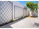 Private courtyard space featuring a white brick wall and mature tree providing shade at 7161 E Mcdonald E Dr # 2, Paradise Valley, AZ 85253
