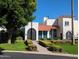 Inviting home with lush landscaping, brick accents, and an arched entry gate at 7161 E Mcdonald E Dr # 2, Paradise Valley, AZ 85253