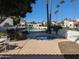 Community pool and hot tub surrounded by manicured landscaping and palm trees at 7161 E Mcdonald E Dr # 2, Paradise Valley, AZ 85253