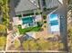 An aerial shot showcasing a home with a modern pool, covered patios, and a pickleball court at 7662 W Artemisa Ave, Peoria, AZ 85383