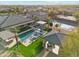 Aerial perspective of luxurious backyard boasting a sparkling pool, spa, cabana, and sports court for recreation at 7662 W Artemisa Ave, Peoria, AZ 85383