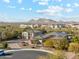 Expansive desert neighborhood aerial shot highlighting home with circular driveway, detached garage, and mountain views at 7662 W Artemisa Ave, Peoria, AZ 85383