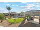 Aerial view of a spacious backyard featuring a pool, outdoor kitchen, pickleball court, and lush landscaping at 7662 W Artemisa Ave, Peoria, AZ 85383