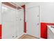 Modern bathroom featuring a glass enclosed shower, white walls, and red accent tiles at 7662 W Artemisa Ave, Peoria, AZ 85383