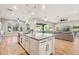 Spacious kitchen with a large center island, pendant lighting, and views into the living room at 7662 W Artemisa Ave, Peoria, AZ 85383