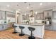 Stylish kitchen featuring an island with bar seating, stainless steel appliances, and modern lighting at 7662 W Artemisa Ave, Peoria, AZ 85383