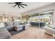 Open floor plan showcasing the living room, kitchen, and sliding glass doors leading to the outdoor living area at 7662 W Artemisa Ave, Peoria, AZ 85383