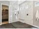 Shower with black fixtures, bench and marble-look tile, open to closet at 7662 W Artemisa Ave, Peoria, AZ 85383