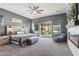 Spacious main bedroom with ceiling fan, fireplace and sliding glass doors leading to pool at 7662 W Artemisa Ave, Peoria, AZ 85383