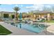 Beautiful pool area with lush landscaping, pergola-covered lounge, and an outdoor kitchen, ideal for entertaining at 7662 W Artemisa Ave, Peoria, AZ 85383