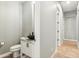 Elegant powder room features a vessel sink, wood look floors and modern fixtures at 7662 W Artemisa Ave, Peoria, AZ 85383