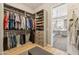 Custom walk-in closet with ample shelving and hanging space, next to the bathroom at 7662 W Artemisa Ave, Peoria, AZ 85383