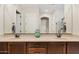 Bathroom vanity featuring dual sinks, granite countertops, and decorative accents at 7717 W Noble Prairie Way, Florence, AZ 85132