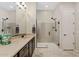 Bright bathroom featuring a glass-enclosed shower, tile flooring, and a granite-topped vanity at 7717 W Noble Prairie Way, Florence, AZ 85132