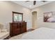 A serene bedroom boasts a beautiful wood dresser, a calming color palette, and an inviting atmosphere at 7717 W Noble Prairie Way, Florence, AZ 85132