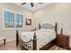 Cozy bedroom with wood-look flooring and iron bed frame at 7717 W Noble Prairie Way, Florence, AZ 85132