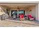 An inviting covered patio with dining and seating areas, perfect for enjoying the outdoors at 7717 W Noble Prairie Way, Florence, AZ 85132